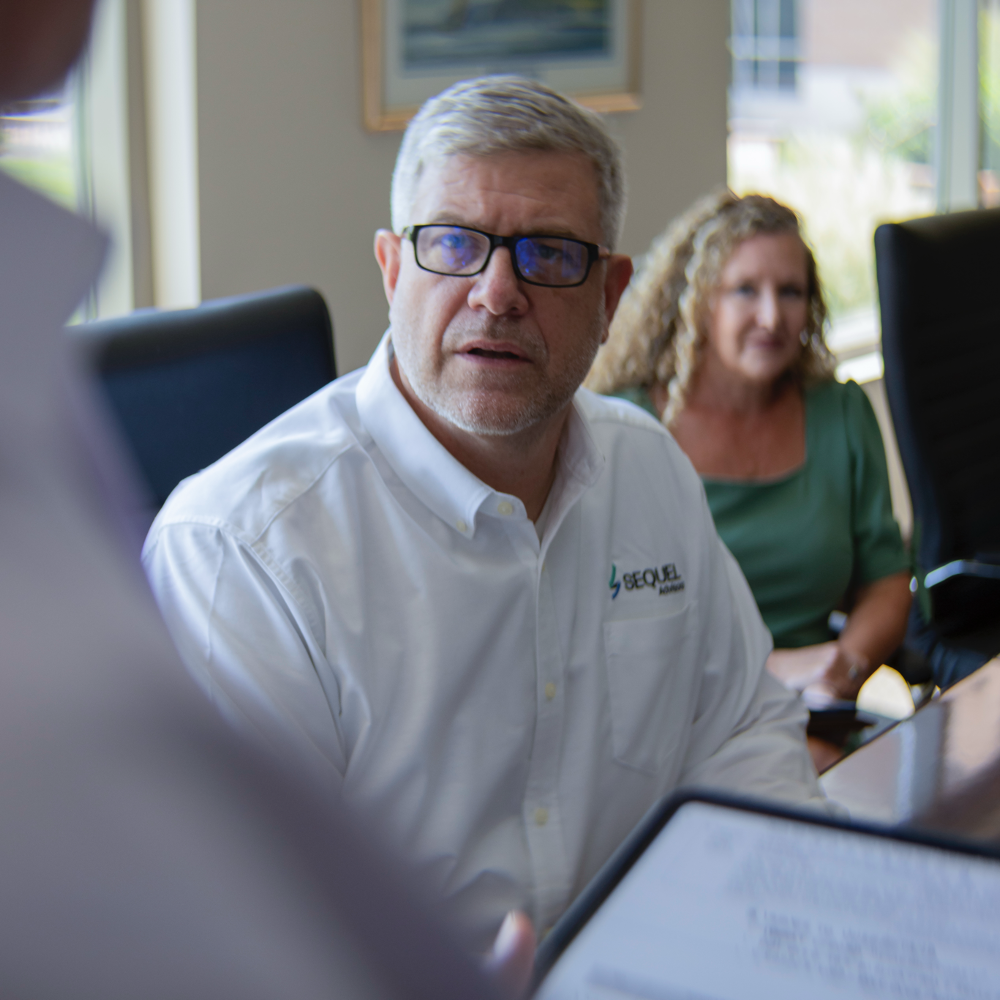 An investment banker looking intently at a presenter